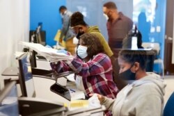 Officials work on ballots at the Gwinnett County Voter Registration and Elections Headquarters, Nov. 6, 2020, in Lawrenceville, near Atlanta, Georgia.