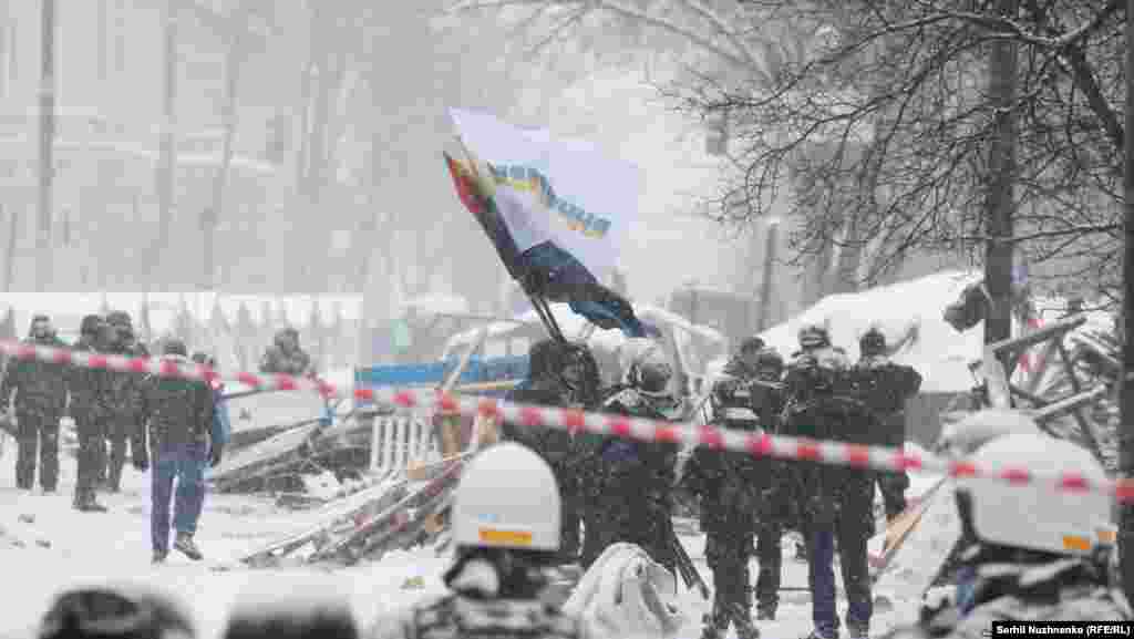 Riot police remove a tent camp set up last October by supporters of Mikheil Saakashvili, who are demanding President Petro Poroshenko resign, detaining over 100 people, in Kyiv, Ukraine, March 3, 2018.