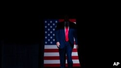 FILE - President Donald Trump arrives on stage to speak at a campaign rally at the BOK Center in Tulsa, Oklahoma, June 20, 2020.