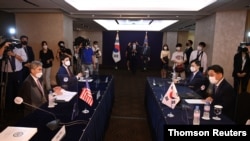 Noh Kyu-duk (R), South Korea's Special Representative for Korean Peninsula Peace and Security Affairs, talks with Sung Kim (L), US Special Representative for North Korea, during their bilateral meeting at a hotel in Seoul, June 21, 2021.