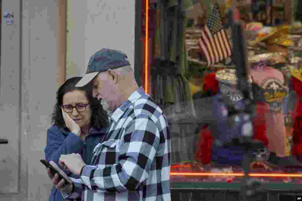 People react at the intersection of Bourbon Street and Canal Street during the investigation after a pickup truck rammed into a crowd of revelers early on New Year&#39;s Day, Jan. 1, 2025, in New Orleans.