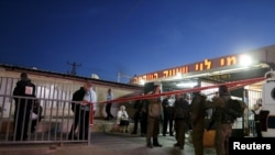 Israeli troops gather near a supermarket that was the scene of a stabbing near the West Bank city of Ramallah, Feb. 18, 2016.