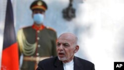 FILE - Afghan President Ashraf Ghani speaks during a joint news conference with Pakistan Prime Minister Imran Khan at the Presidential Palace in Kabul, Afghanistan, Nov. 19, 2020.