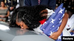 Myeshia Johnson, wife of U.S. Army Sergeant La David Johnson, who was among four special forces soldiers killed in Niger, kisses his coffin at a graveside service in Hollywood, Florida, October 21, 2017. (REUTERS/Joe Skipper) 