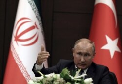 FILE - Russia's President Vladimir Putin speaks during a joint news conference with Turkish President Recep Tayyip Erdogan and Iran's President Hassan Rouhani, in Ankara, Turkey, Sept. 16, 2019.