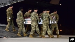 In this image provided by the U.S. Air Force, a U.S. Army carry team transfers the remains of Army Staff Sgt. Dustin Wright of Lyons, Georgia, Oct. 5, 2017, upon arrival at Dover Air Force Base, Delware. Wright, 29, was one of four U.S. troops and four Niger forces killed in an ambush by dozens of Islamic extremists. 