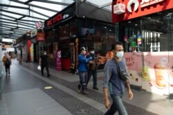 Pedestrian wear face masks on a shopping district in Kuala Lumpur, Malaysia, Jan. 14, 2021.