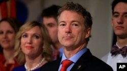 FILE - Republican presidential candidate, Sen. Rand Paul, R-Ky, stands with his wife, Kelley, as he waits to speaks to supporters during a caucus night party at the Scottish Rite Consistory in Des Moines, Iowa, Feb. 1, 2016.