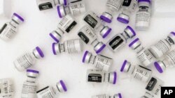 FILE: Vials of the Pfizer-BioNTech COVID-19 vaccine sit in a cooler before being thawed at a pop-up COVID-19 vaccination site in the Bronx borough of New York on Jan. 26, 2021. 