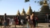 Mro ethnic people displaced from the surge of fighting between ethnic armed rebel group of the Arakan Army and government troops take refuge at a compound of a Buddhist pagoda are seen during a government-organized visit for journalists in Buthidaung town