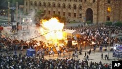 Gas-filled balloons explode during a campaign rally concert in the central Republic Square in Yerevan, Armenia, May 4, 2012.