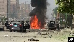 Black smoke billows from a burning car moments after a bomb attack targeted the convoy of Egypt's Interior Minister Mohammed Ibrahim, in Nasr City, Egypt, Sept. 5, 2013 (AP Photo File)
