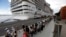 FILE - Passengers disembark from the cruise ship MSC Preziosa, in the Port Area of Rio de Janeiro, Brazil, Jan. 2, 2022, after Brazil confirmed more cases of COVID-19 on board.