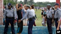 A spectator is searched by police before entering the venue for a Rolling Stones concert in Havana, Cuba, March 25, 2016. 