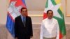 In this photo provided by An Khoun Sam Aun/National Television of Cambodia, Cambodian Prime Minister Hun Sen poses for photographs together with Myanmar General Min Aung Hlaing before holding a meeting in Naypyitaw, Myanmar, Friday Jan. 7, 2022. 