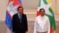 In this photo provided by An Khoun Sam Aun/National Television of Cambodia, Cambodian Prime Minister Hun Sen poses for photographs together with Myanmar General Min Aung Hlaing before holding a meeting in Naypyitaw, Myanmar, Friday Jan. 7, 2022. 