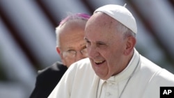 FILE - Pope Francis arrives to hold a Mass in Holguin, Cuba, Sept. 21, 2015.