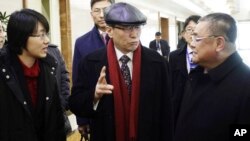 Wu Dawei, center, China's special representative for Korean Peninsula Affairs, is greeted by Pak Song Il, right, deputy director of the America department at the North Korean Foreign Ministry, upon arrival in Pyongyang, Feb. 2, 2016. 