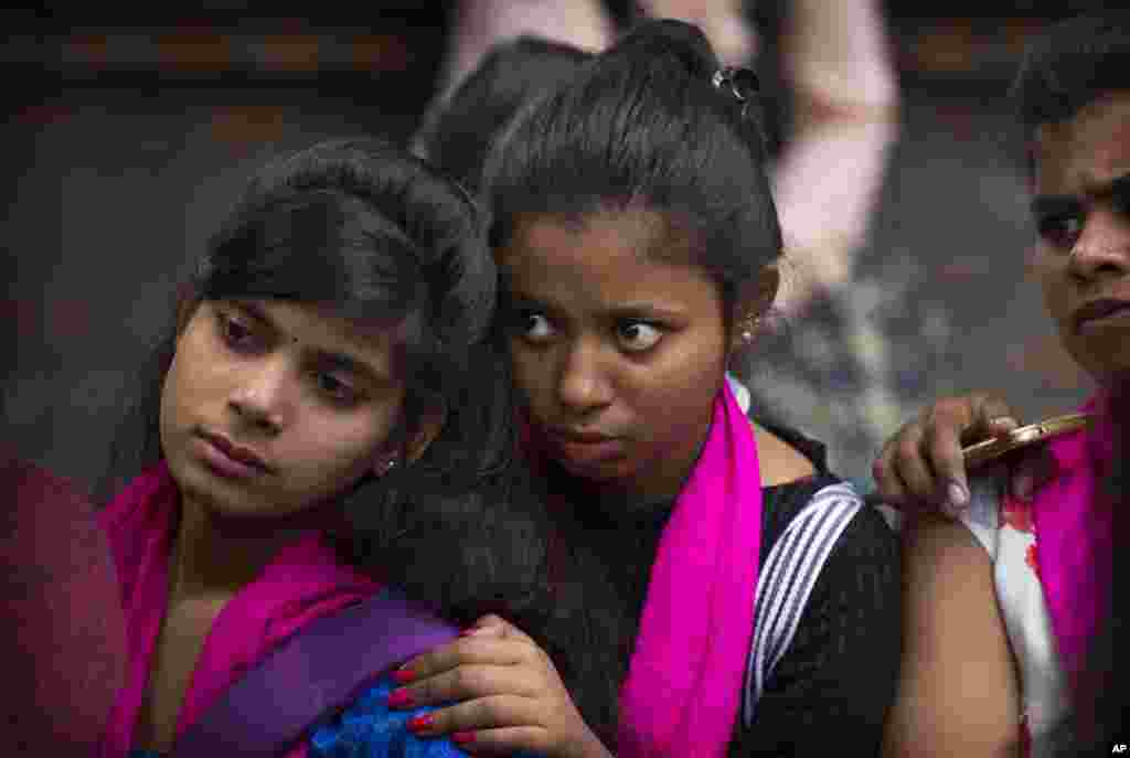 A group of women watch a street play on domestic violence before the start of a march to mark International Women's Day in New Delhi, India, March 8, 2019.