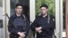 Russian police officers guard the entrance of the building where Russian opposition leader Alexei Navalny resides during a police search in Moscow, June 11, 2012. 