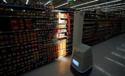 In this Nov. 9, 2018, photo, a robot scans shelves to provide real-time inventory data at a Walmart Supercenter in Houston.