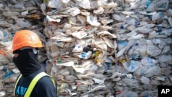 FILE - A container is filled with plastic waste from Australia, in Port Klang, Malaysia, May 28, 2019.