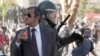 Backstory - As a Riot Rages, a Smartly-dressed Chilean Sips His Soda