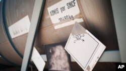 FILE - A chemical container is seen in an unguarded storage facility in the desert, some 62 miles (100 kilometers) south of Sirte, Libya.