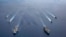 In this photo provided by U.S. Navy, the USS Ronald Reagan (CVN 76) and USS Nimitz (CVN 68) Carrier Strike Groups steam in formation, in the South China Sea, July 6, 2020. 