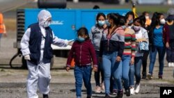FILE - Unaccompanied Guatemalan children who were deported by plane from Mexico arrive at La Aurora International Airport in Guatemala City, Aug. 26, 2021, amid the COVID-19 pandemic.