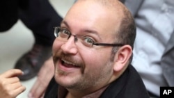 FILE - Jason Rezaian, an Iranian-American correspondent for the Washington Post smiles as he attends a presidential campaign of President Hassan Rouhani in Tehran, Iran.