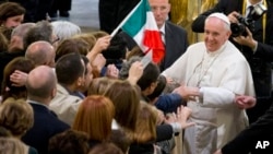FILE - Pope Francis meets with relatives of Mafia victims in Rome's St. Gregorio VII church near the Vatican, March 21, 2014.