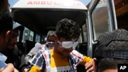 A Kashmiri man whose eyes were injured with pellets during a clash with Indian security forces in south Kashmir arrives for treatment at a hospital in Srinagar, India, May 29, 2019.
