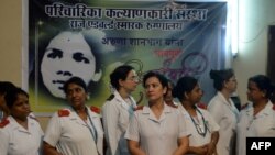 FILE - Indian nurses gather to pay their respects for nurse Aruna Shanbaug at a hospital in Mumbai, India, May 18, 2015. Shanbaug died on May 18 after 42 years in a coma following a brutal rape, in a case that led India to ease some restrictions on euthan