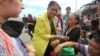 United Nations Under-Secretary General for Humanitarian Affairs, Valerie Amos (C), speaks to typhoon survivors at the airport in Tacloban, central Philippines, Nov. 13, 2013.