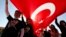 Youth are seen in Ankara holding Turkey's national flag and wearing T-shirts adorned with the image of Mustafa Kemal Ataturk, secular Turkey's founder (file photo).