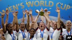 United States' Megan Rapinoe lifts up a trophy after winning the Women's World Cup final soccer match between US and The Netherlands at the Stade de Lyon in Decines, outside Lyon, France, Sunday, July 7, 2019. (AP Photo/Alessandra Tarantino)