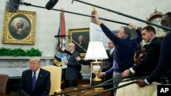 President Donald Trump listens as he meets with Kazakhstan's President Nursultan Nazarbayev in the Oval Office, Jan. 16, 2018.