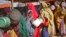 FILE - Women who fled drought queue to receive food at a camp for internally displaced persons, in the Daynile neighborhood on the outskirts of the capital Mogadishu, Somalia, May 18, 2019. 