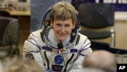 FILE - U.S. astronaut Peggy Whitson, member of the main crew of the expedition to the International Space Station, speaks with her relatives prior the launch of Soyuz MS-3 space ship at the Russian-leased Baikonur cosmodrome, Kazakhstan, Nov. 17, 2016.