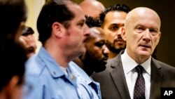 Jadranko Prlic, right, enters the Yugoslav War Crimes Tribunal in The Hague, Netherlands, Nov. 29, 2017, to hear the verdict in the appeals case.