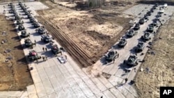 FILE - This handout photo released April 22, 2021, by the Russian Defense Ministry Press Service shows Russian military vehicles during drills in Crimea, a Black Sea peninsula Russia annexed from Ukraine in 2014.