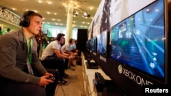 FILE - A gamer plays "Call of Duty: Advanced Warfare" on an Xbox One console during the Xbox Play Day 2014, before the Gamescom 2014 fair in Cologne August 12, 2014. (REUTERS/Wolfgang Rattay)