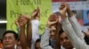 Members of the opposition Cambodia National Rescue Party raise joined hands for photographs at their party headquarters in Phnom Penh, May 27, 2016.