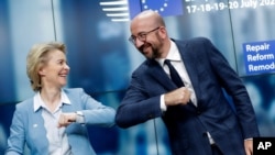 European Commission President Ursula von der Leyen, left, and European Council President Charles Michel bump elbows after addressing a media conference at an EU summit in Brussels, Tuesday, July 21, 2020. Weary European Union leaders finally…