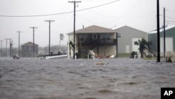 A home damaged by Hurricane Harvey remains surrounded by flood waters, Aug. 26, 2017, in Rockport, Texas. 