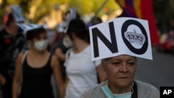 FILE - Demonstrators march during a protest against Spanish Monarchy in Madrid, Spain, July 25, 2020.