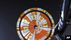 This illustration provided by NASA shows a diagram added over the parachute deployed during the descent of the Mars Perseverance rover as it approaches the surface of the planet on Feb. 18, 2021. 