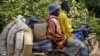 FILE - An Ivorian refugee gets a lift on motor bike taxi toward Zwedru, Liberia, March 24, 2011.