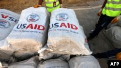 ເຈົ້າ​ໜ້າ​ທີ່​ສະ​ໜາມ​ບິນກວດ​ກາ​ສິ່ງ​ຂອງ​ການ​ຊ່ວຍ​ເຫຼືອ​ດ້ານ​ມະ​ນຸດ​ສະ​ທຳ ຫຼັງ​ຈາກ​ການ​ຊ່ວຍ​ເຫຼືອໜັກ 60 ໂຕນ​ຈາກ​ອົງ​ການ USAID ຖືກ​ຂົນ​ລົງ​ຈາກ​ເຮືອ​ບິນ​ຢູ່​ສະ​ໜາມ​ບິນ ອາ​ບິ​ລ, ອີ​ຣັກ, 2 ກັນ​ຍາ 2014.